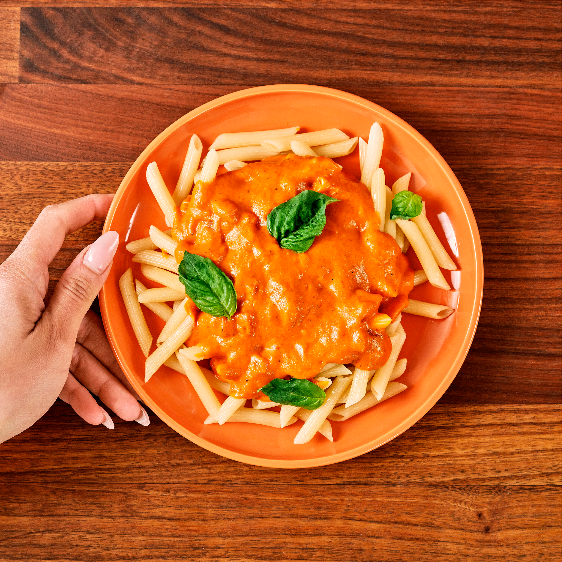 High fiber penne pasta plated on table, overhead view