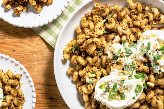 Pasta dish with a creamy topping on a wooden table