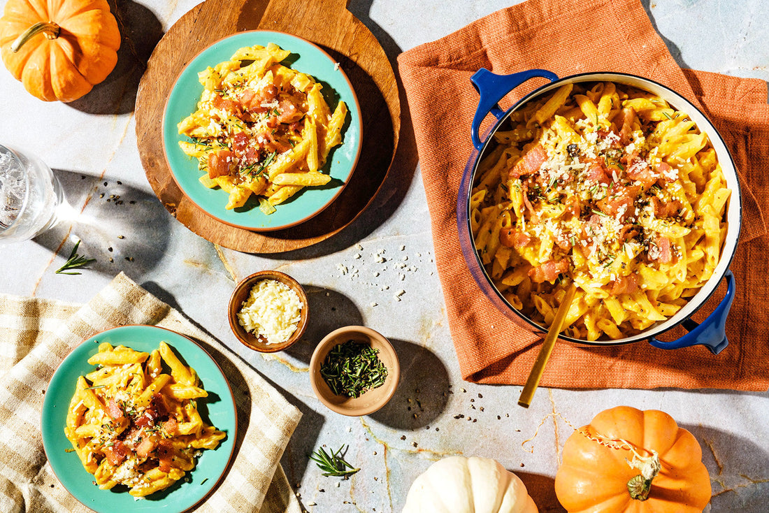 Pasta dish with pumpkins on a table setting