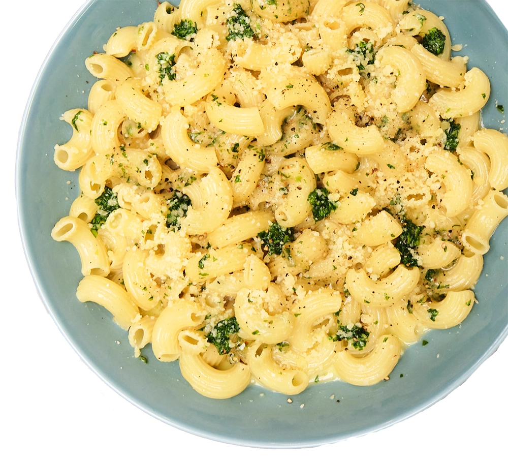 A blue bowl of elbow pasta with herbs and parmesan cheese