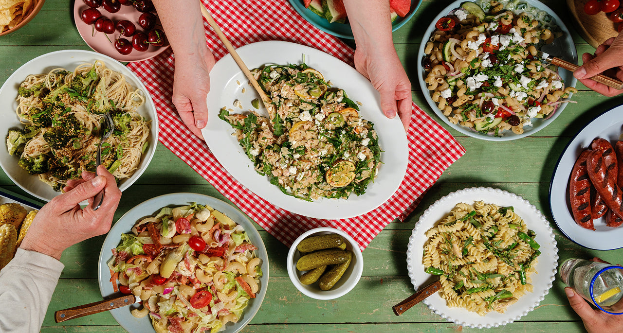 People enjoying a meal together with various dishes on a table.
