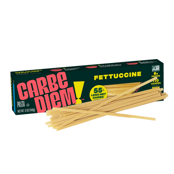 Front of Carbe Diem Fettuccine box with pasta strands piled in front.