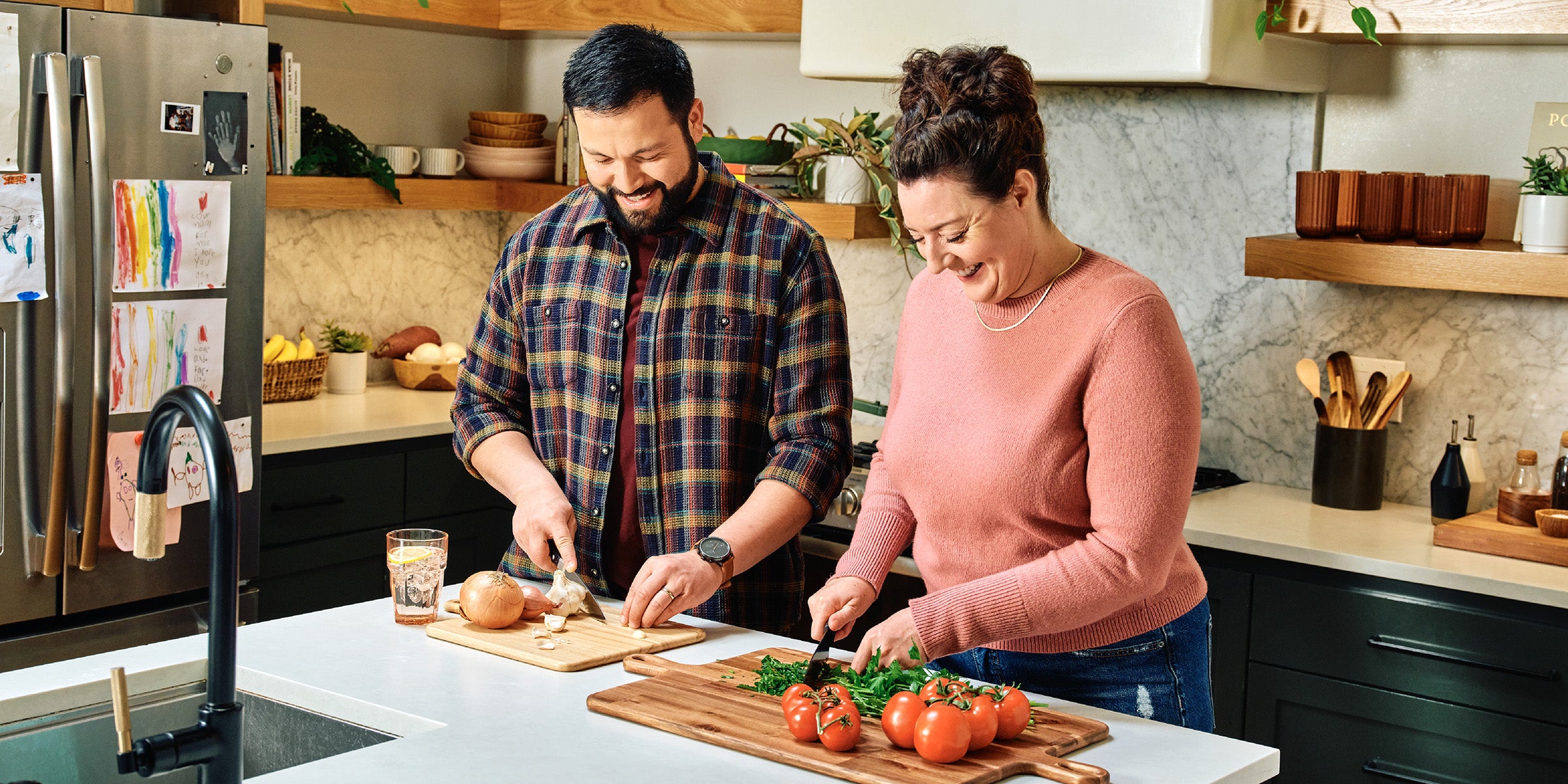 Man and woman preparing food together in a kitchen
