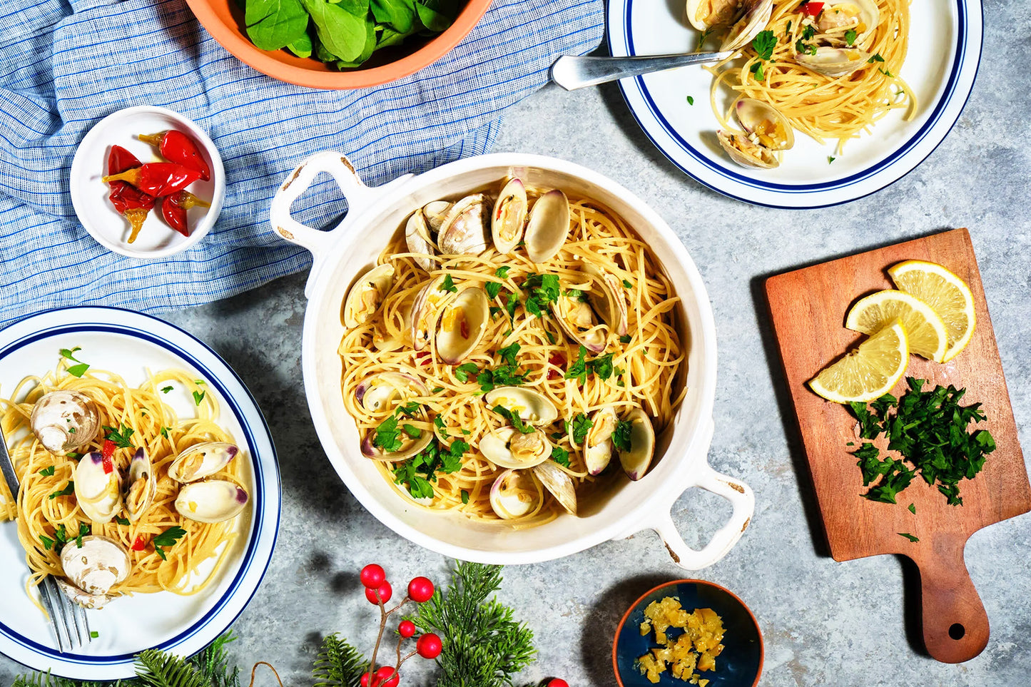 A pot of spaghetti with clams and herbs.