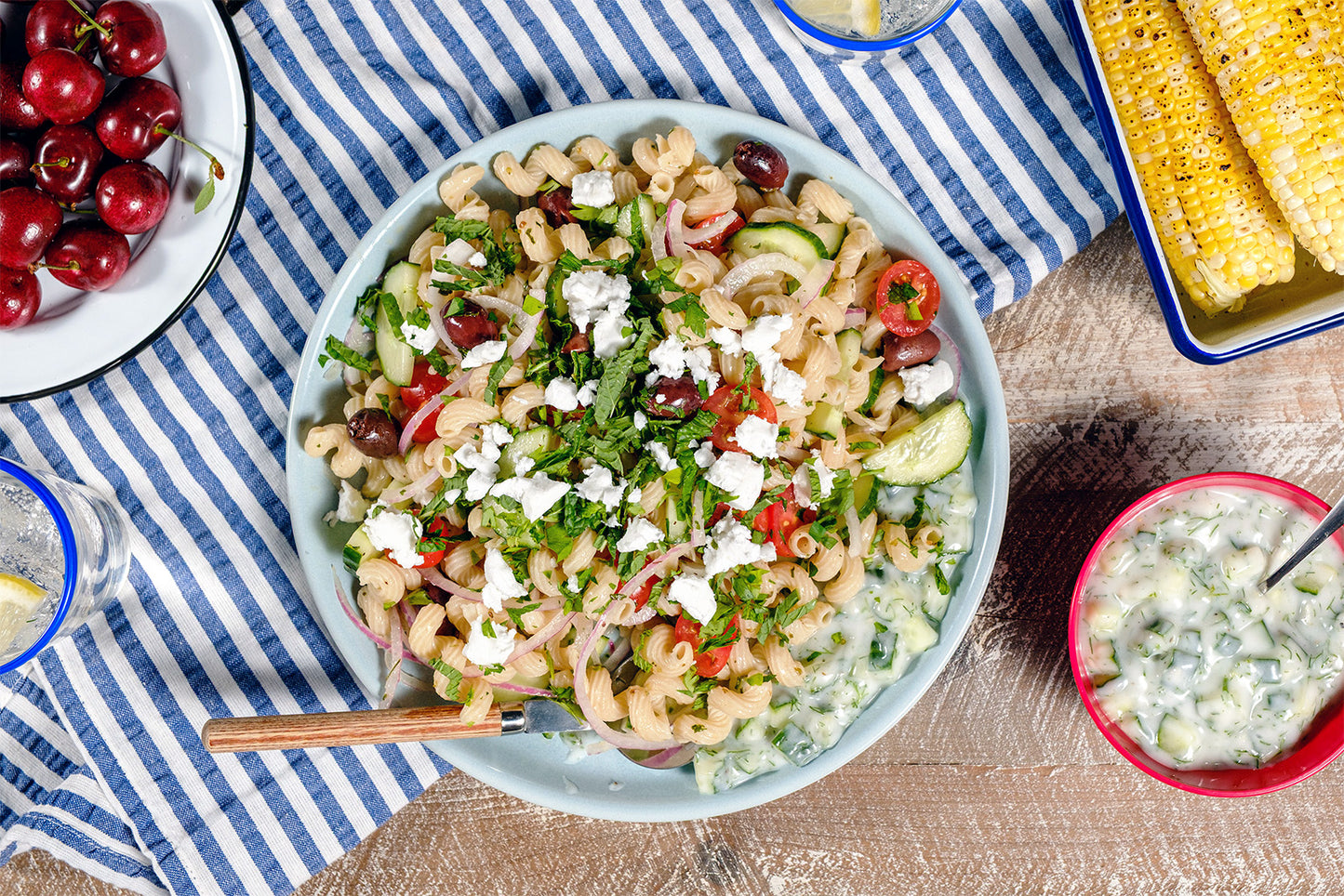 Pasta salad with vegetables on a striped tablecloth