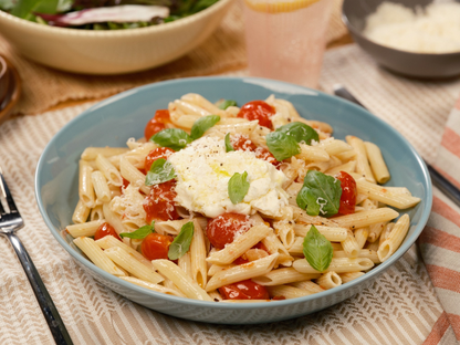 Reduced calorie penne pasta from Carbe Diem plated on table, side view