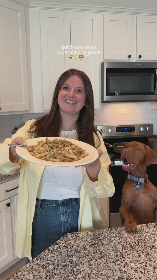 Load video: A woman showing off her bowl of homemade pasta.