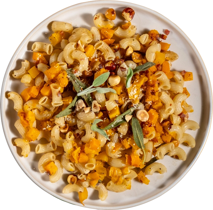 Pasta dish with butternut squash and sage on a white plate